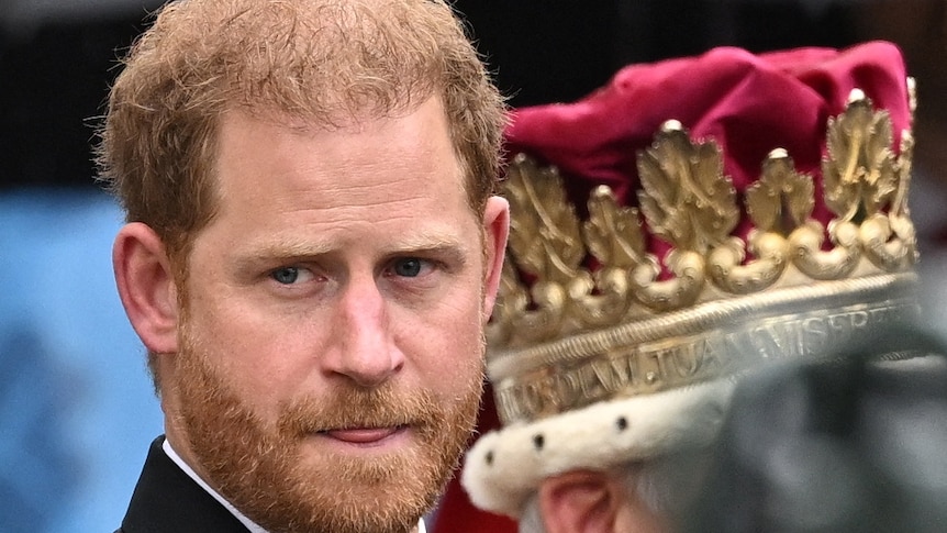 Britain's Prince Harry walks outside Westminster Abbey.