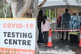 A 'COVID-19 testing centre' sign outside a clinic.