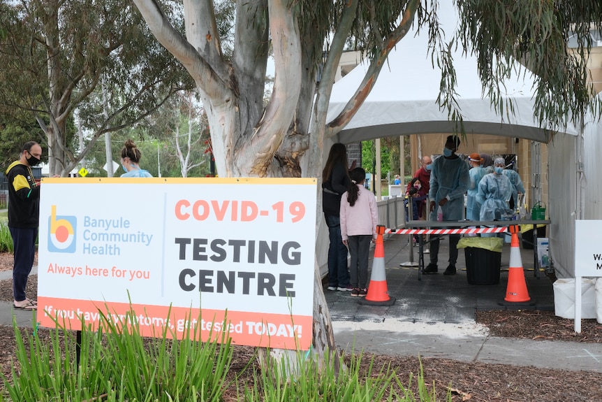 A 'COVID-19 testing centre' sign outside a clinic.