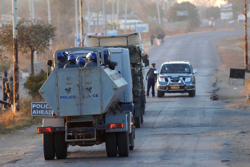 A truck carrying police enters a neighbourhood in Harare, Friday, July, 31, 2020.