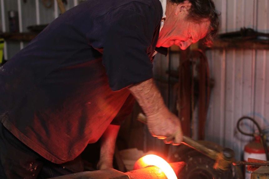 Blacksmith Bill Jackson shapes a horseshoe for a Clydesdale