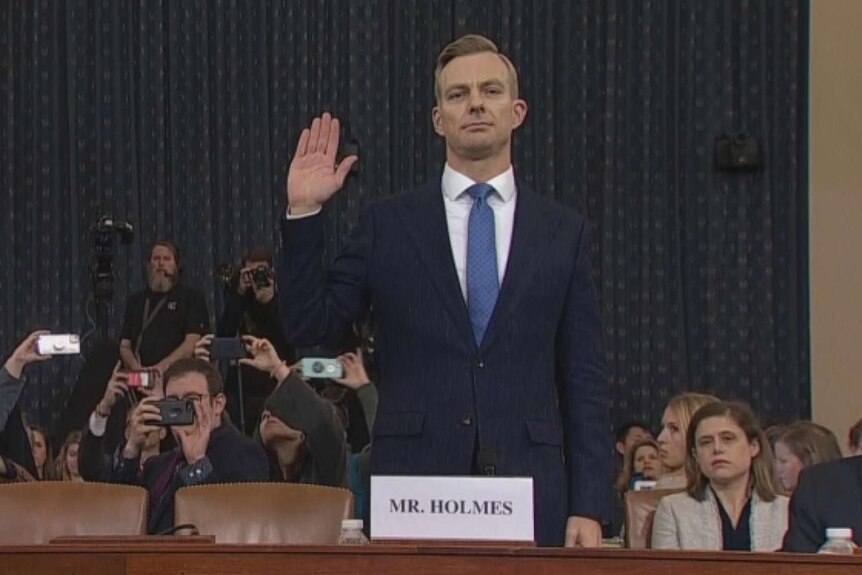 David Holmes, a US Embassy Official raises his hand in oath in the House chambers