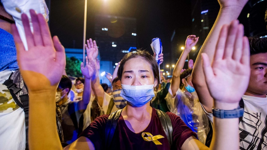 Demonstrator with hands up