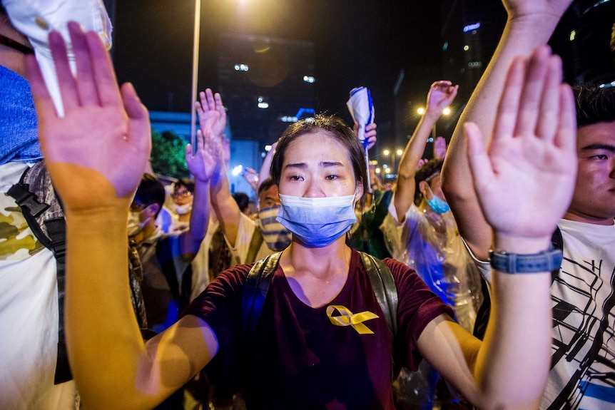 Demonstrator with hands up