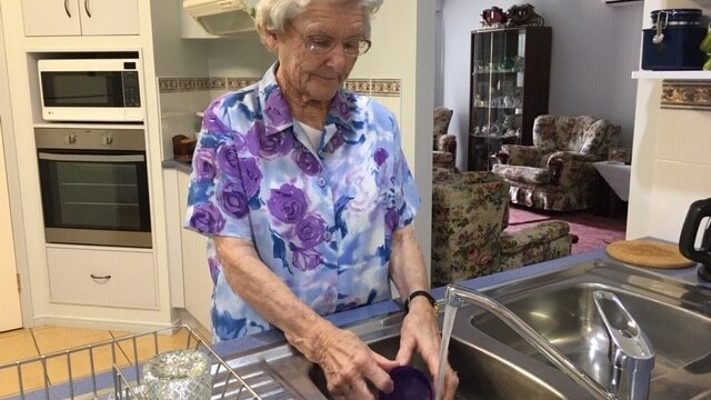 Pensioner Verlene Johnson washing up in her Ballina home