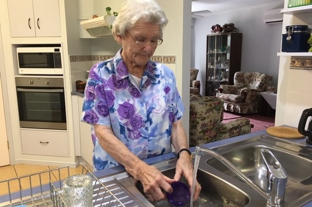 Pensioner Verlene Johnson washing up in her Ballina home