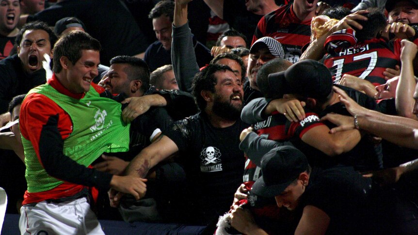 Western Sydney Wanderers players celebrate with supporters after Youssouf Hersi (17) scored.