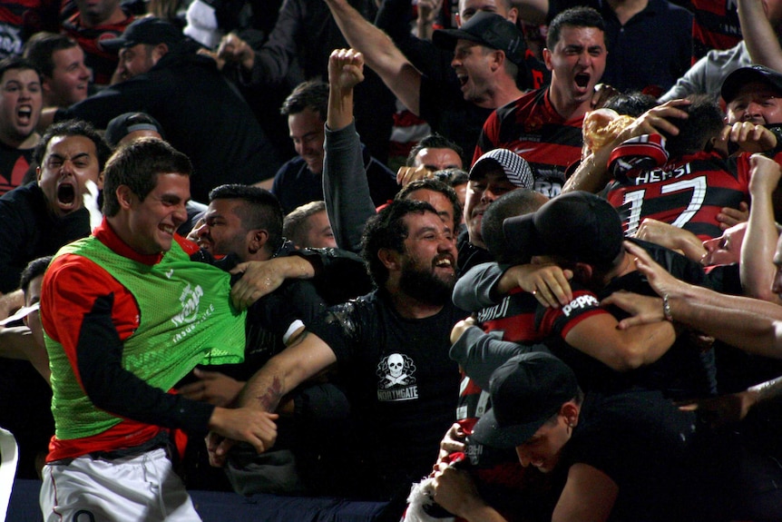 Western Sydney Wanderers players celebrate with supporters after Youssouf Hersi (17) scored.