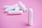 Tampons on pink background