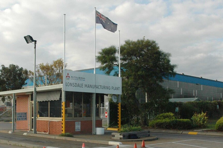 A manufacturing plant with a Mitsubishi sign out the front