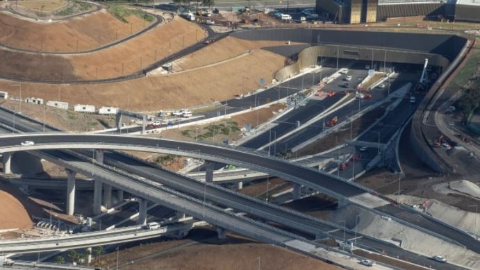 An aerial view of a work site including a spaghetti junction of roads.