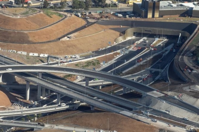 An aerial view of a work site including a spaghetti junction of roads.