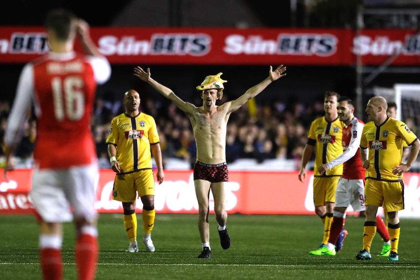 Streaker with giraffe mask runs onto field during Sutton v Arsenal game