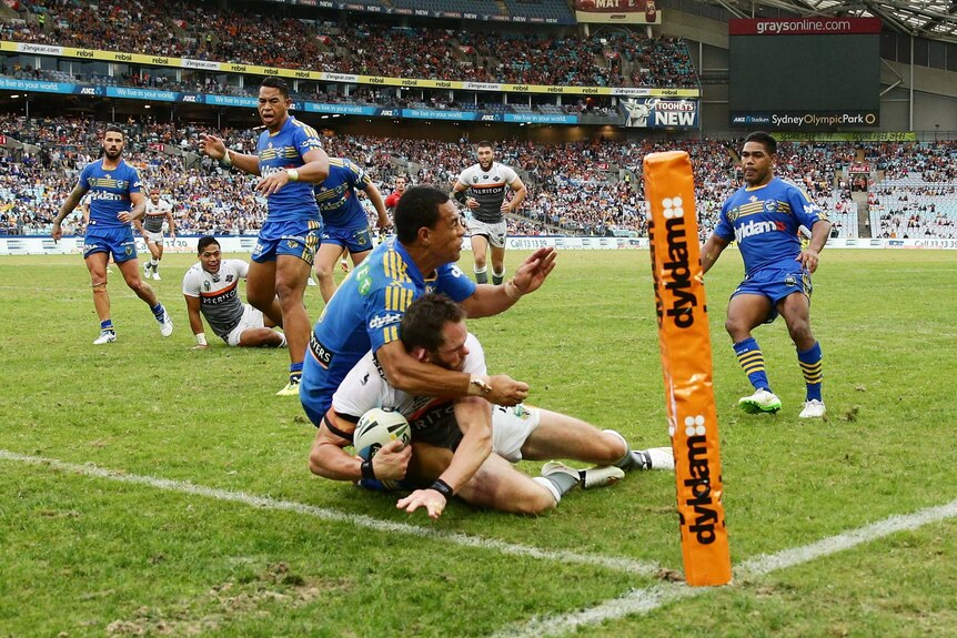 Pat Richards cops a high shot from Will Hopoate as he scores a try