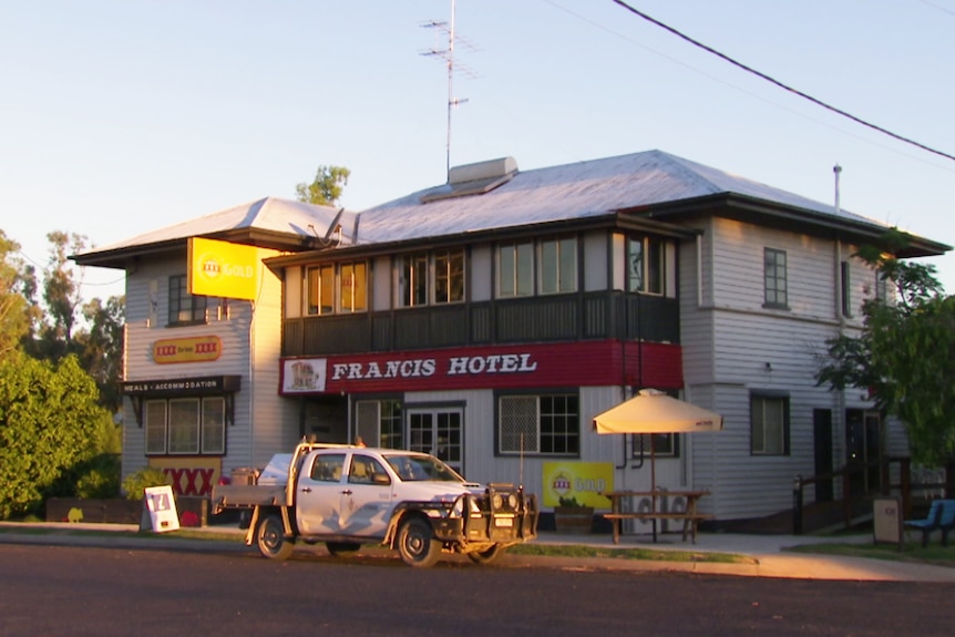 An outback pub in Queensland with a white ute out the front.