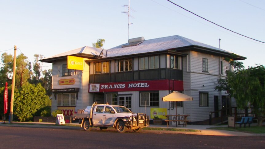 An outback pub in Queensland with a white ute out the front.