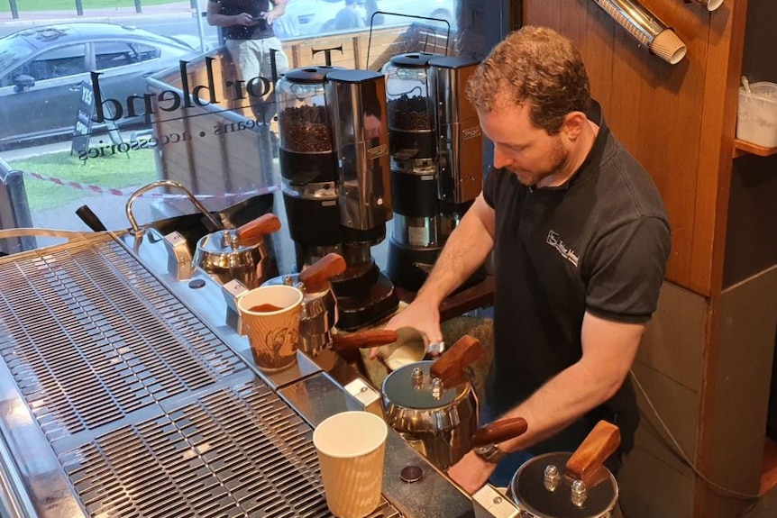 Jos Taylor pouring milk into a coffee cup