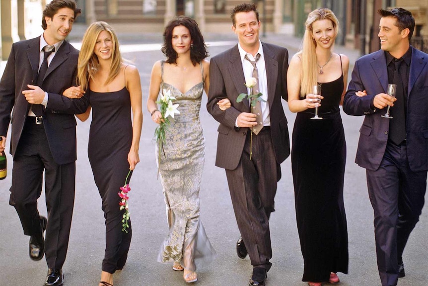 Cast of Friends walk together. 