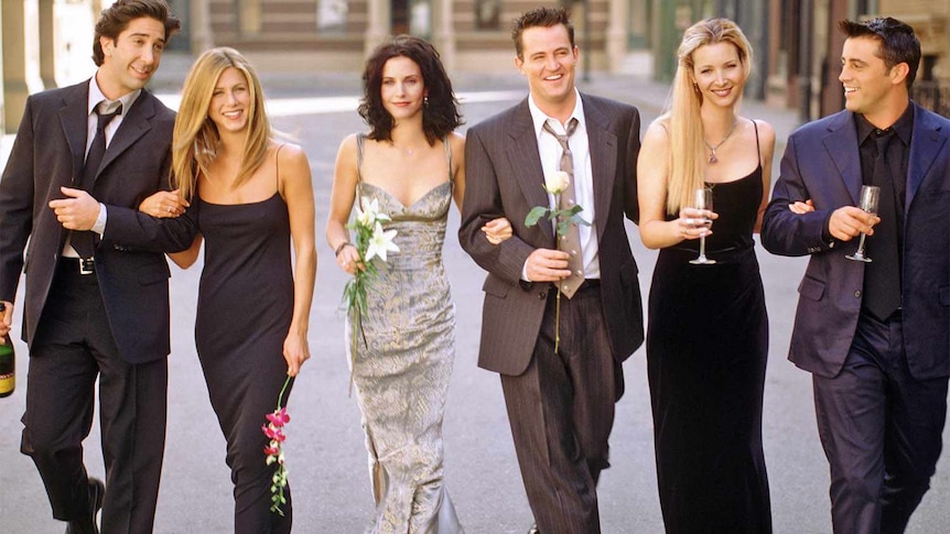 Cast of Friends walk together. 