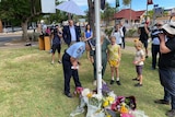 Commissioner Katarina Carroll lays flowers at the Chinchilla police station.