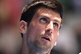 Steely focus ... Novak Djokovic serves to Andrey Kuznetsov