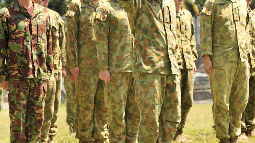 Australian soldiers stand to attention in East Timor in November 2009 - no faces identifiable