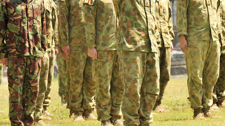 Unidentified Australian soldiers stand to attention.