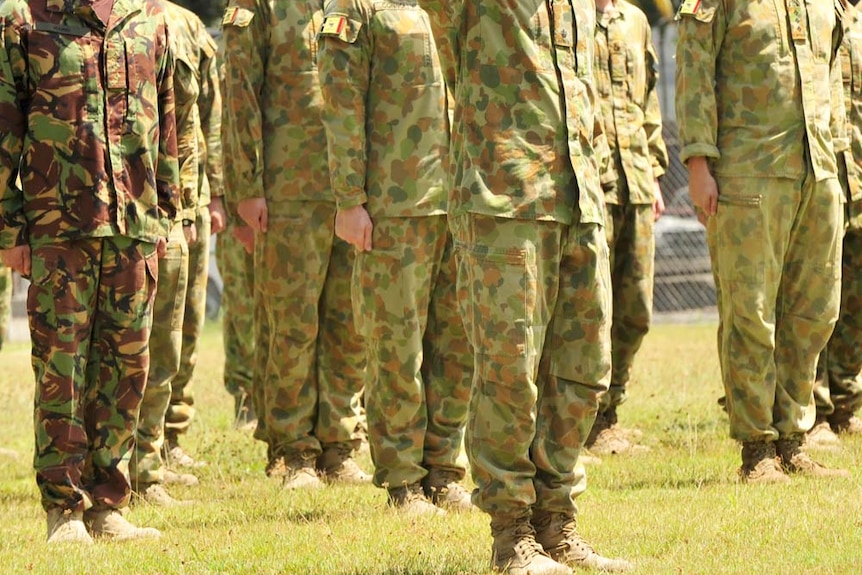 Unidentified Australian soldiers stand to attention.