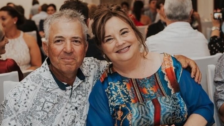 James Bugeja sitting next to his wife at a formal dinner event.