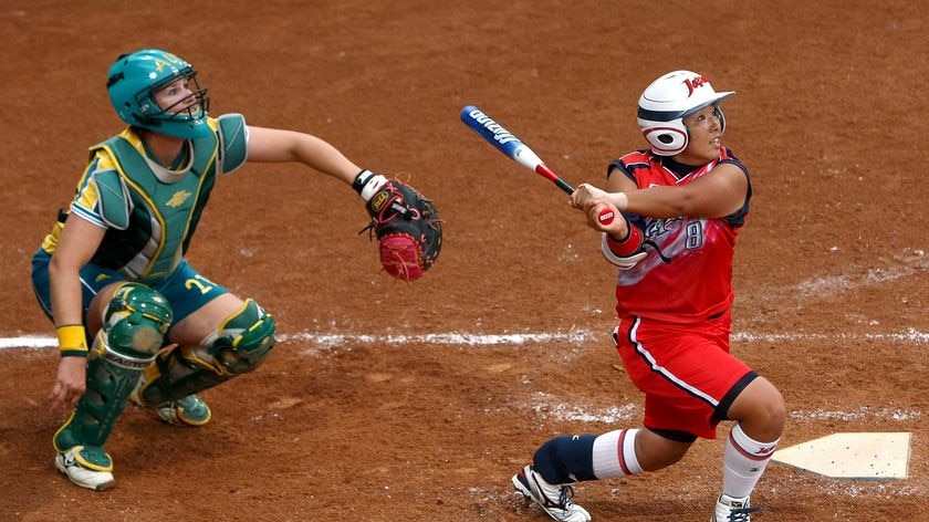 Japan's Megu Hirose and Australia's Natalie Titcume look on as Hirose hits a two-run home run