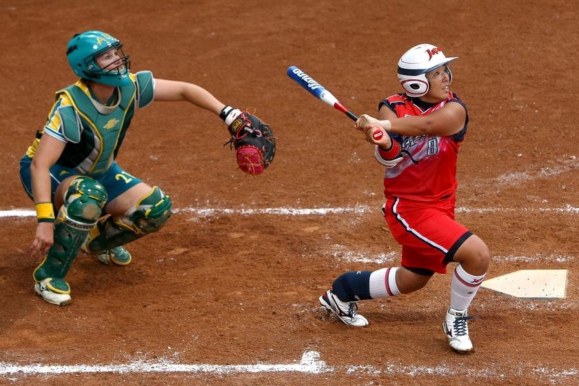 Japan's Megu Hirose and Australia's Natalie Titcume look on as Hirose hits a two-run home run