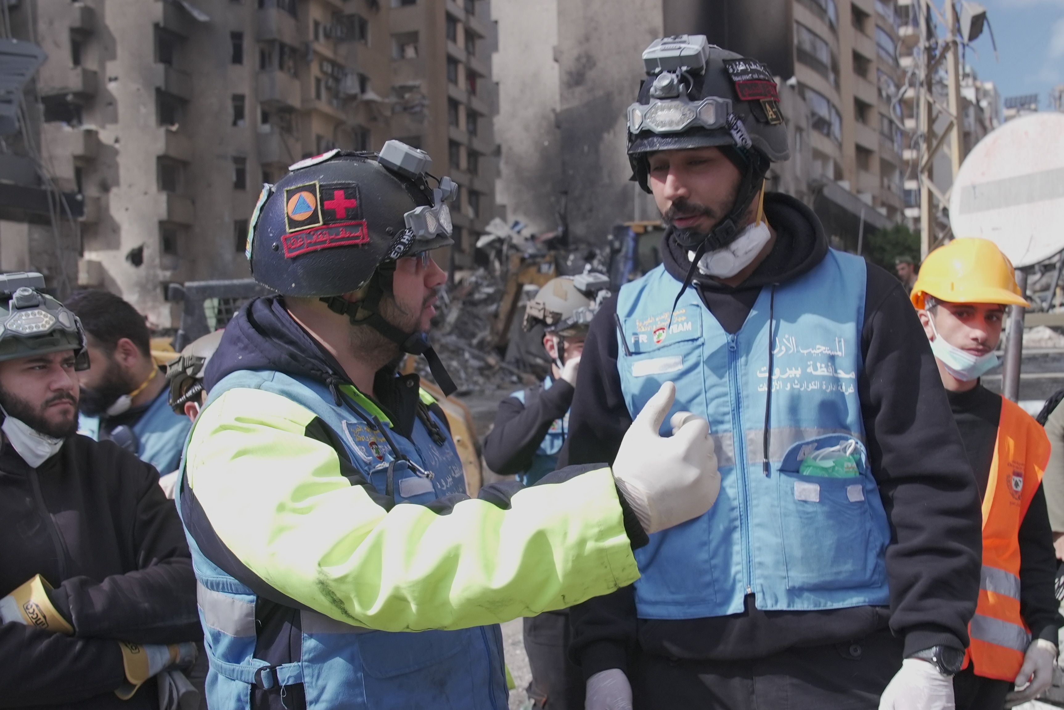 Two paramedics in front of wreckage in Beirut.
