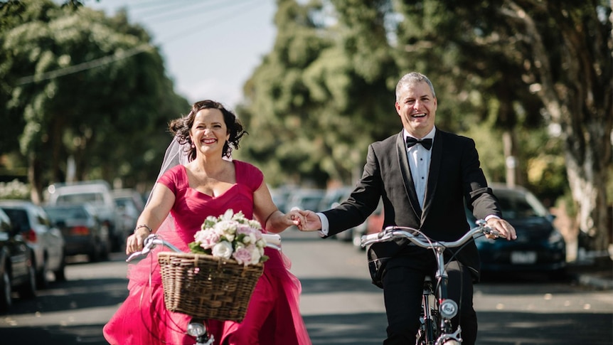 Catherine Deveny and her partner arrive at their Love Party on bikes.