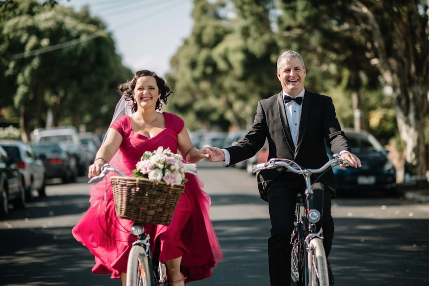 Catherine Deveny and her partner arrive at their Love Party on bikes.