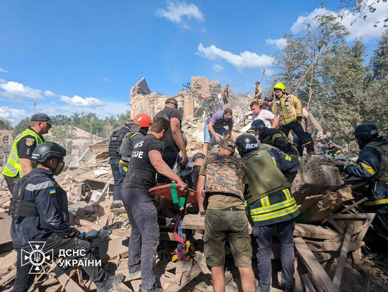 Rescuers working at missile strike site. 