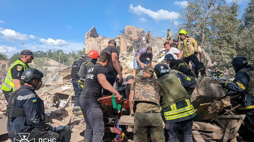 Rescuers working at missile strike site. 