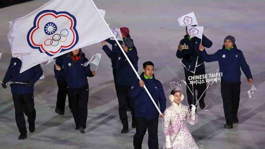 A Taiwanese athlete carries the Chinese Taipei flag representing Taiwan during the opening ceremony of the 2018 Winter Olympics.