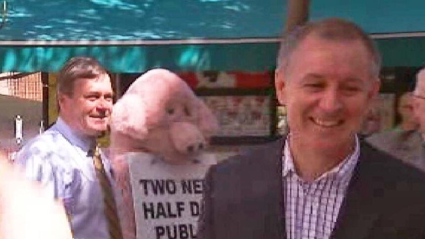 Penalty rates message put by a dress-up 'pig' to Jay Weatherill