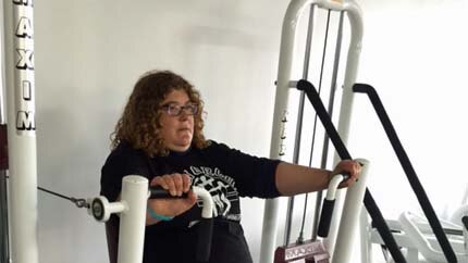 Amber Meredith uses gym equipment.