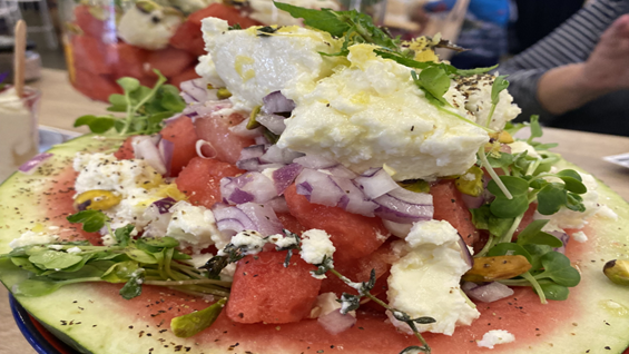 image of watermelon salad topped with white goat's cheese and red onion