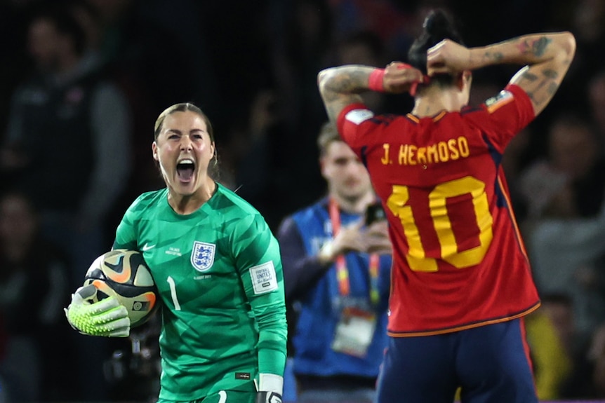 England goalkeeper Mary Earps shouts at Spain's Jenni Hermoso after saving a penalty in the Women's World Cup final.
