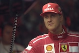 Michael Schumacher looks to one side in Ferrari kit