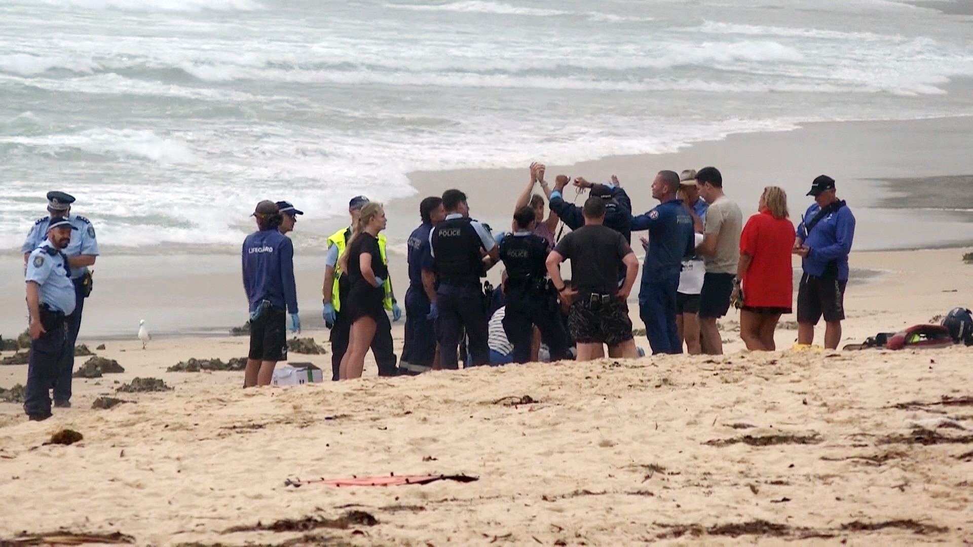 Emergency services on the sand at north steyne beach after a man was bitten by a shark