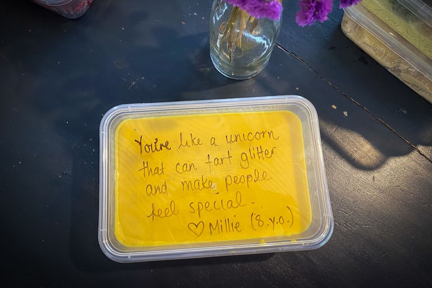 A food container with a message on the lid that says "You're like a unicorn that can fart glitter and make people feel special."