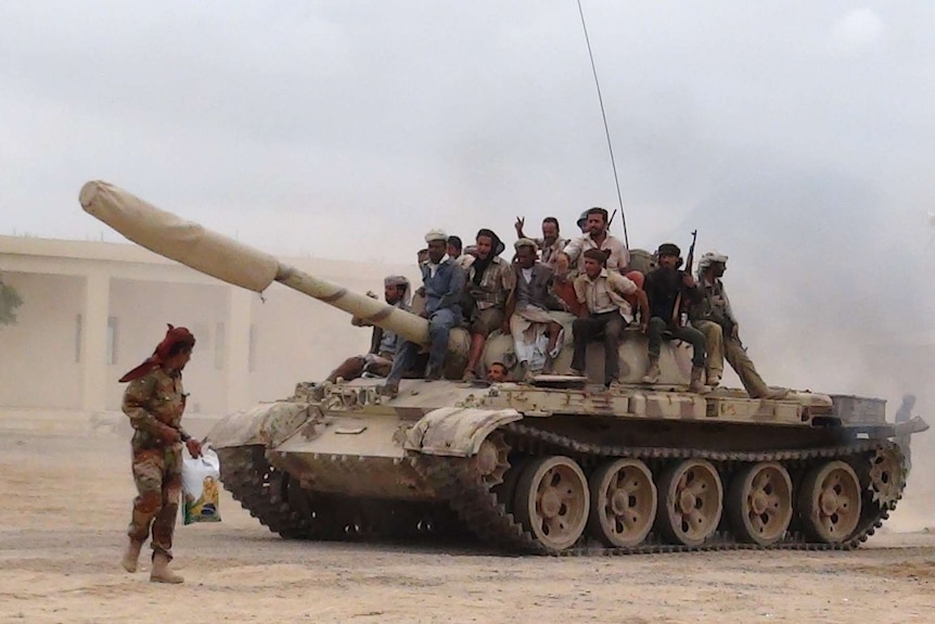 Militants loyal to Yemen's president Abd-Rabbu Mansour Hadi move a tank