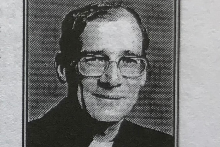 An old black and white photo of Father Laurie Gallagher.