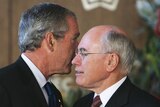 Welcomed: US President George W Bush whispers to John Howard as he is greeted at the Opera House