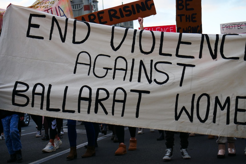 a banner says end violence against ballarat women