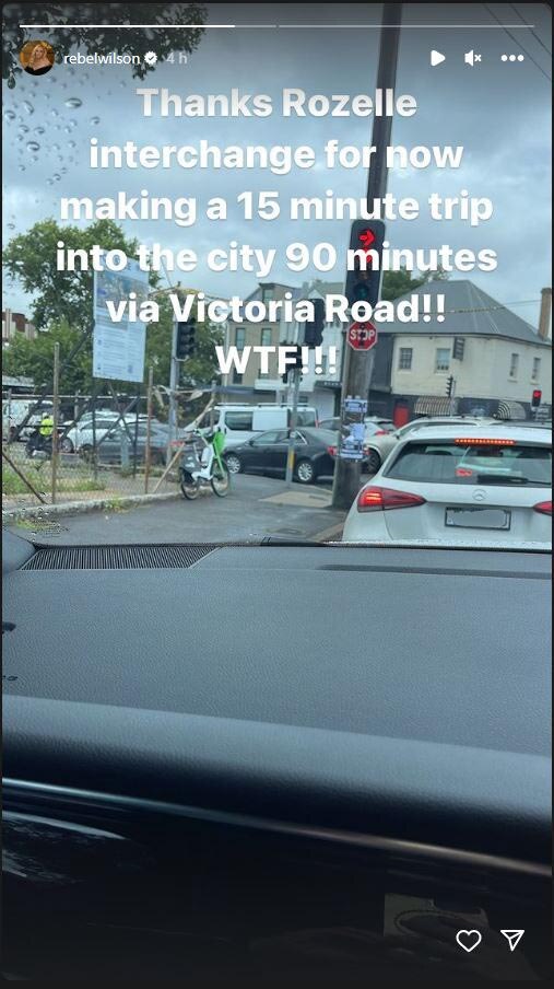 text caption over a rainy car window view of traffic and buildings