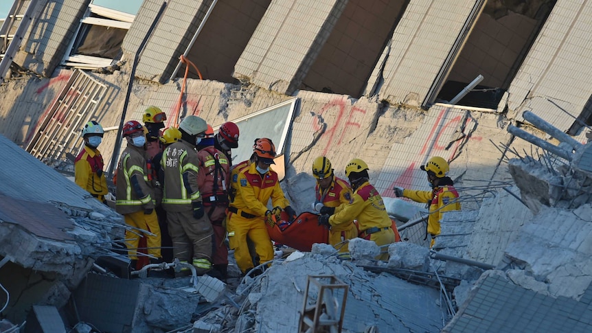Rescuers bring out survivor from building which collapsed in Taiwan earthquake